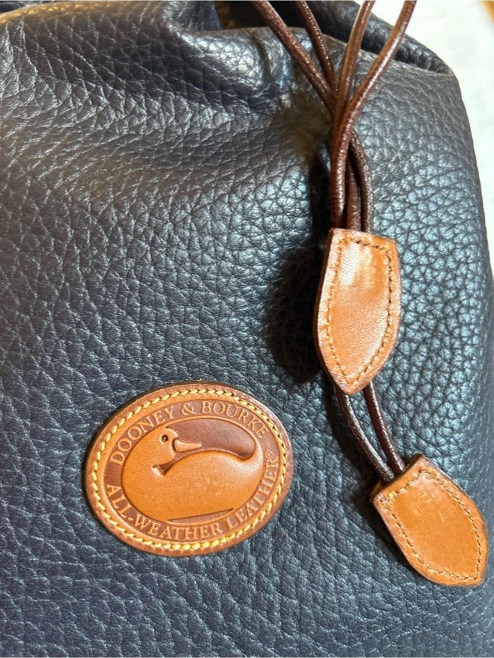 Dooney & Bourke Black Pebbled Leather Drawstring Backpack with Brown Trim